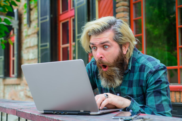 Online,Lottery.,Excited,Man,With,Laptop,Outdoors.,Winning,Online.,Surprised