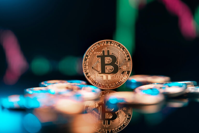 Bitcoin,Cryptocurrency,With,Colorfull,Blurred,Candlestick,Chart,In,The,Background