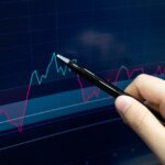 Stock,Market.,Pointing,At,Screen,Analysing,Market,Trend,Line