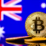 Gold,Metal,Coin,Bitcoin,On,The,Background,Of,The,Flag